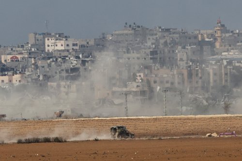 Israeli military vehicle operates, near the Israel-Gaza border, as seen from southern Israel