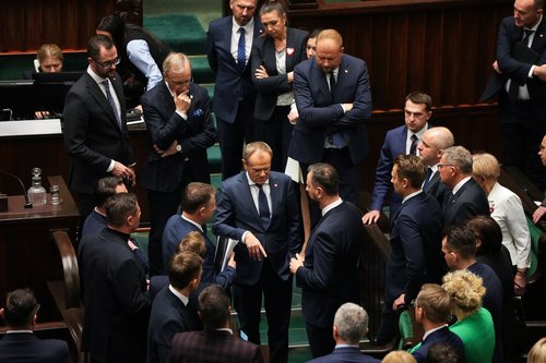 Newly appointed Polish PM Donald Tusk talks with MPs at the Parliament in Warsaw