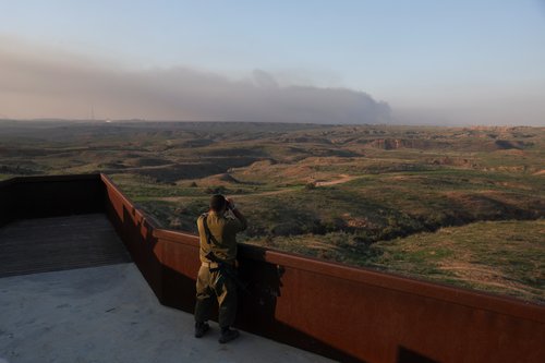 An Israeli soldier looks towards Gaza near the border, in southern Israel