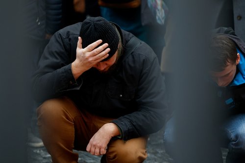 People hold a vigil to honour victims of Prague shooting