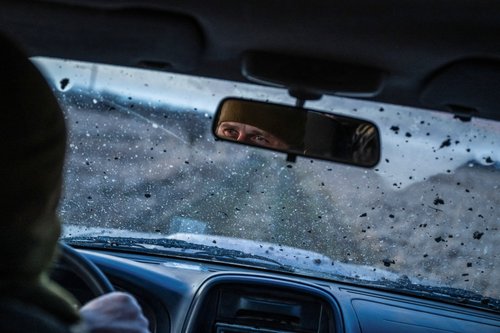 Ukrainian Army sniper drives a car on a road near the frontline town of Bakhmut