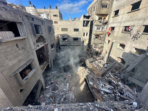 Palestinians inspect the site of an Israeli strike on a house in Rafah in the southern Gaza Strip