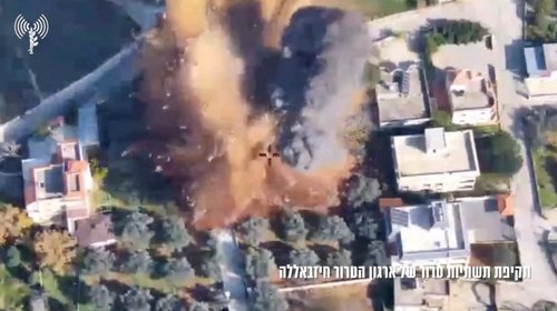 Aerial view of a strike on a building and surrounding area in the location given as Lebanon