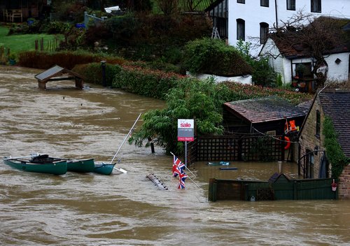 A home is surrounded from flood water from the River Severn after heavy rain from Storm Henk