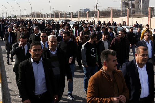 People demonstrate in front of the United Nations headquarters in Erbil