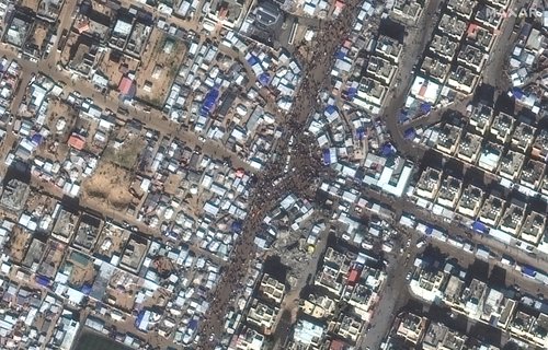 A satellite image shows people gathering on the streets in Rafah