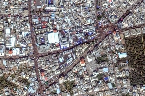 A satellite image shows people gathering on the streets in Rafah
