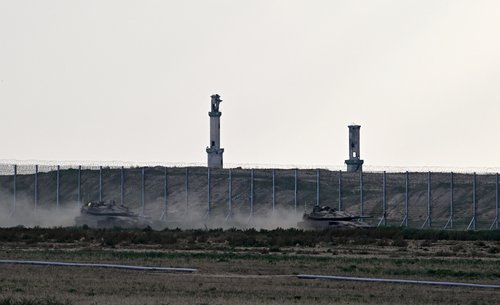 Tanks manoeuvre along the border with Gaza, as seen from Israel