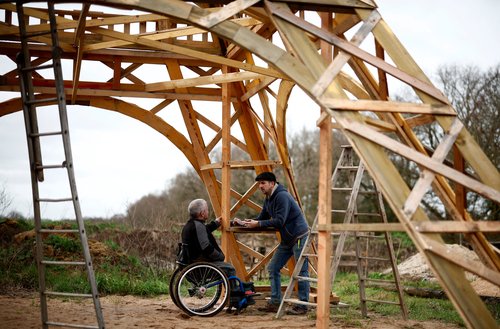 A French carpenter builds a replica of the Eiffel Tower from recycled wood in western France