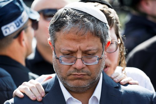 Israeli officials work at the scene of what Israel's police describe as a suspected shooting attack near Bnei Reem