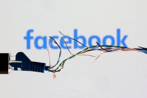 FILE PHOTO: Illustration shows Broken Ethernet cable and Facebook logo