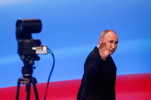 Russian incumbent President Putin leaves following his speech, in Moscow