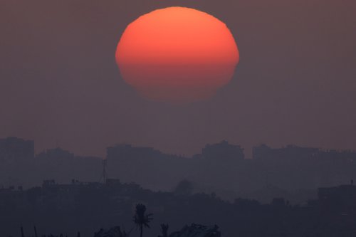 The sun sets over Gaza, as seen from southern Israel