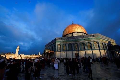 Palestinian Muslims attend Eid al-Fitr prayers which mark the end of Ramadan in Al-Aqsa compound