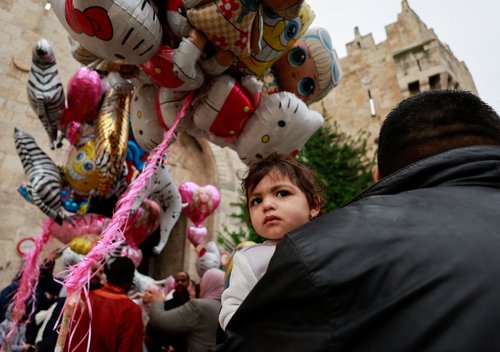 Palestinian Muslims attend Eid al-Fitr prayers which mark the end of Ramadan in Al-Aqsa compound
