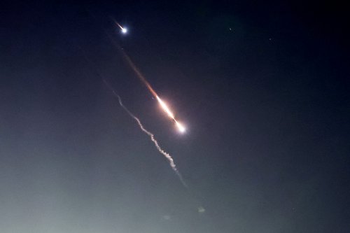 Objects are seen in the sky above Jerusalem after Iran launched drones and missiles towards Israel, in Jerusalem
