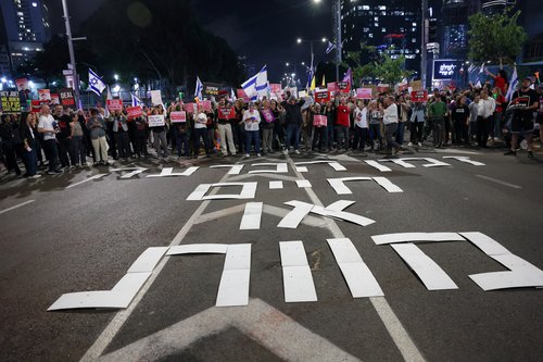People attend a protest demanding the immediate release of hostages, in Tel Aviv