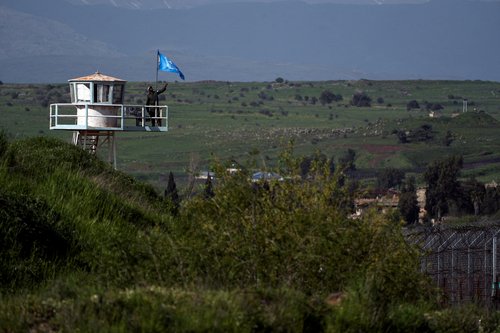FILE PHOTO: A U.N. peacekeeper guards at a post along the Israel-Syria border in the Israeli-occupied Golan Heights