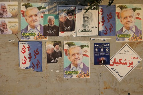 Posters of presidential candidates Masoud Pezeshkian and Saeed Jalili are displayed in a street in Tehran