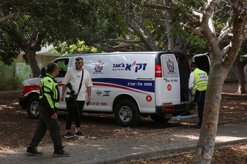 Israeli emergency responders work at the scene of a suspected stabbing attack in Holon