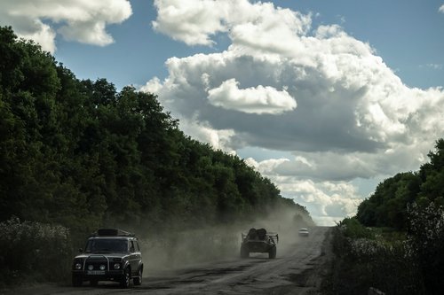 Ukrainian service members ride an Armoured Personnel Carrier near the Russian border in Sumy region
