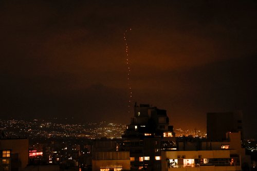 Tracers from firearms fired into the air in celebration for Iran's missiles barrage on Israel