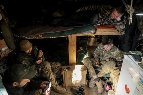 Ukrainian servicemen rest in a dugout at a frontline near the town of Chasiv Yar