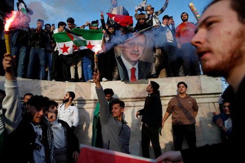 Syrians living in Turkey celebrate after Syrian rebels announced that they have ousted President Bashar al-Assad in Syria, in Istanbul