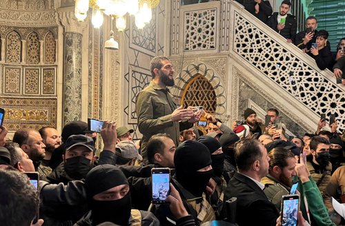 FILE PHOTO: Top rebel commander Abu Mohammed al-Golani speaks to a crowd at Ummayad Mosque in Damascus