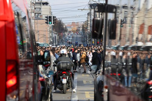 Students gather and block the traffic for fifteen minutes to pay their respect for fifteen victims of a fatal roof collapse at Novi Sad's railway station, in Belgrade