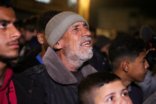 Palestinians react as they wait for news of a ceasefire deal with Israel, in Khan Younis in the southern Gaza Strip