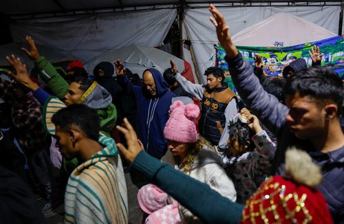 Migrants wait in temporary shelter after CBP One application was shut down, in Matamoros