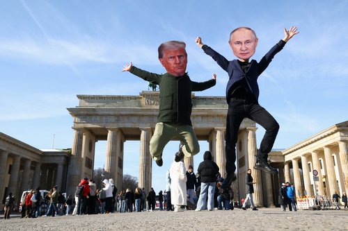 People take part in a protest at the Brandenburg Gate, in Berlin