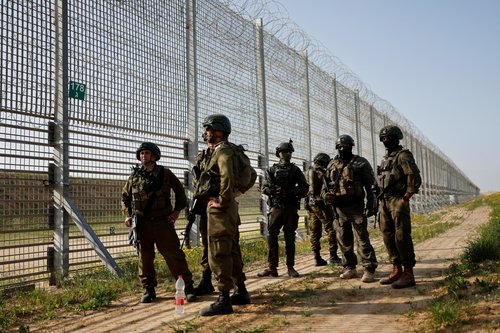 Soldiers keep guard by the Israel-Gaza border fence