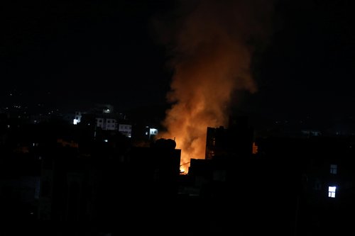 Fire and smoke billows from the site of an air strike in Sanaa