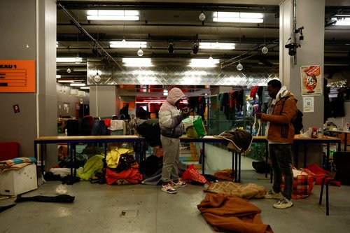 Police evict migrants from a Paris theatre