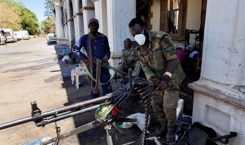 Sudanese army members stand at the presidential palace, after the Sudanese army said it had taken control of the building, in Khartoum