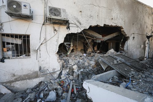 Palestinians inspect damage inside the Al-Ahli Arab Baptist Hospital in Gaza City