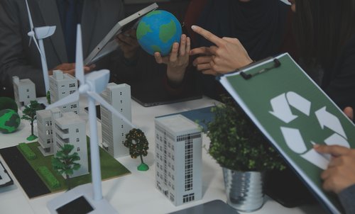 Business people having consultation about wind energy at company