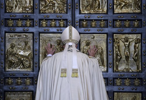FILE PHOTO: Pope Francis opens the Holy Door to mark opening of the Catholic Holy Year, or Jubilee, in St. Peter's basilica