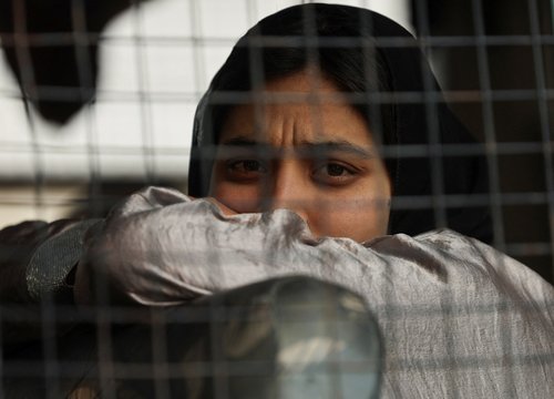 A Pakistani woman sits inside a bus before crossing into Pakistan at the Attari-Wagah border crossing near Amritsar
