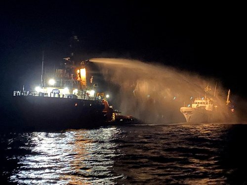 A tug vessel puts out a fire on the Gaza Freedom Flotilla vessel Conscience outside Maltese territorial waters