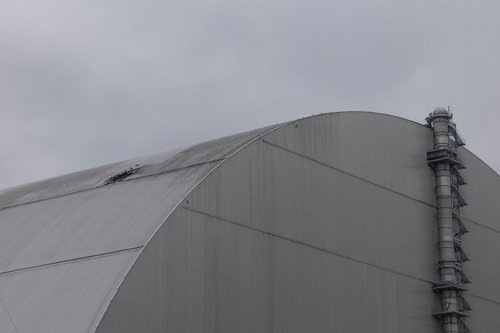 A view shows the New Safe Confinement (NSC) structure, that covers the old sarcophagus which confines the remains of the damaged fourth reactor, and was damaged by a drone strike amid ongoing Russia's attack on Ukraine, at the Chornobyl Nuclear Power Plan
