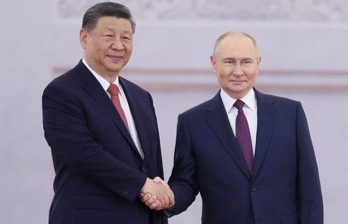Russian President Vladimir Putin shakes hands with his Chinese counterpart Xi