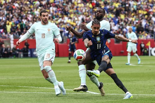 Mar 26, 2026; Foxborough, Massachusetts, USA; Brazil midfielder Raphinha (11) lets go with a shot past France defender Theo Hernandez (19) during the first half at Gillette Stadium. Mandatory Credit: Winslow Townson-Imagn Images