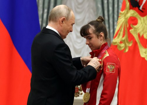 Russia's President Vladimir Putin decorates para cross-country skier and three-time Paralympic champion Anastasia Bagiyan with the Order of Friendship during a ceremony to award members of the Russian Paralympic team, who took part in the 2026 Winter Para