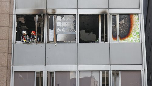 Firefighters are seen at a building where a fire broke out in Osaka