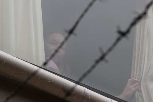 Tennis player Renata Voracova looks out a window from the Park Hotel in Melbourne