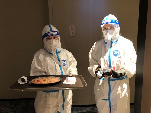 Cocktails and hazmat suits mingle in the Beijing Olympics bubble