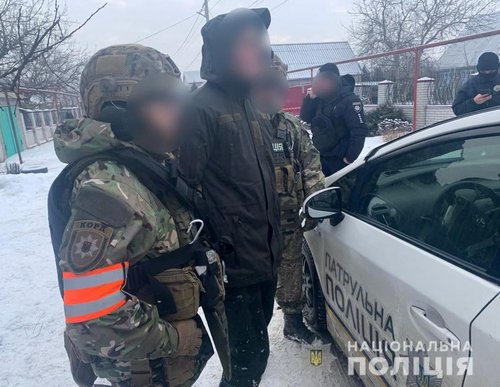 Ukrainian law enforcement officers detain a National Guard soldier following a deadly incident at a military factory in the Dnipropetrovsk region